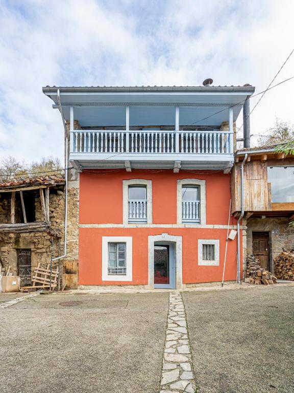 a red house with a balcony on top of it at Benaki 92B in Ladines