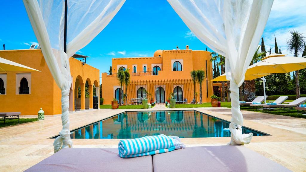 a house with a swimming pool in front of a house at Luxury villa in Azib Oulad Lâdem