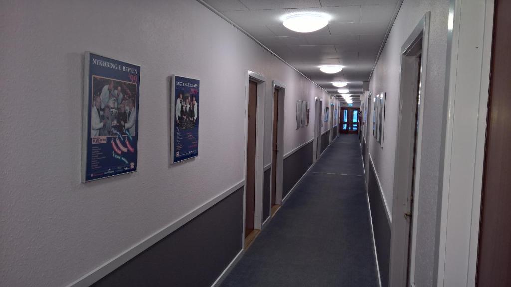 a hallway with posters on the walls of a hospital at Hotel Falster in Nykøbing Falster