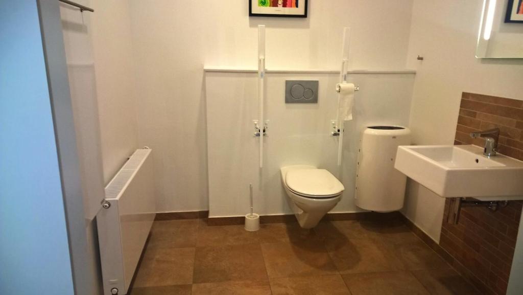 a bathroom with a toilet and a sink at Hotel Falster in Nykøbing Falster
