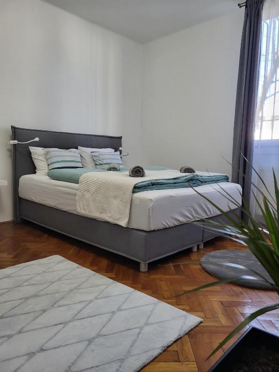 a bed sitting in a room with at Akvamarin Downtown Apartman in Székesfehérvár