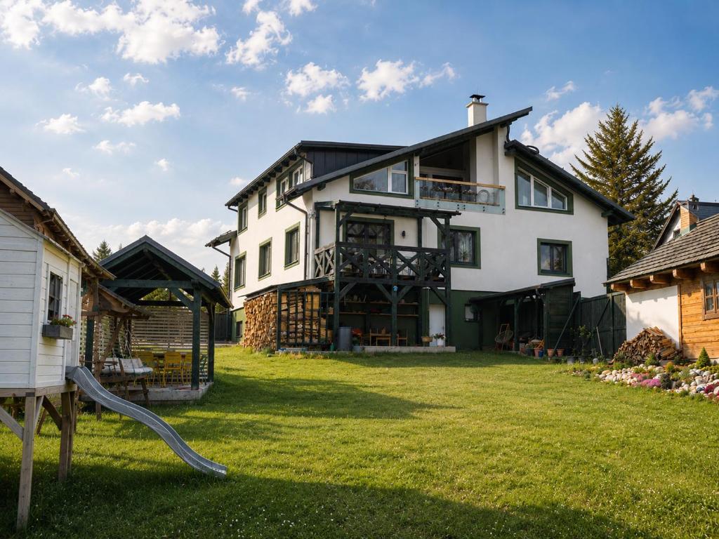 a large white house with a large yard at Cool Mountain Escape - AC - Summer Cinema - 2BR Family Apartment - Garden - Liptov in Liptovská Kokava