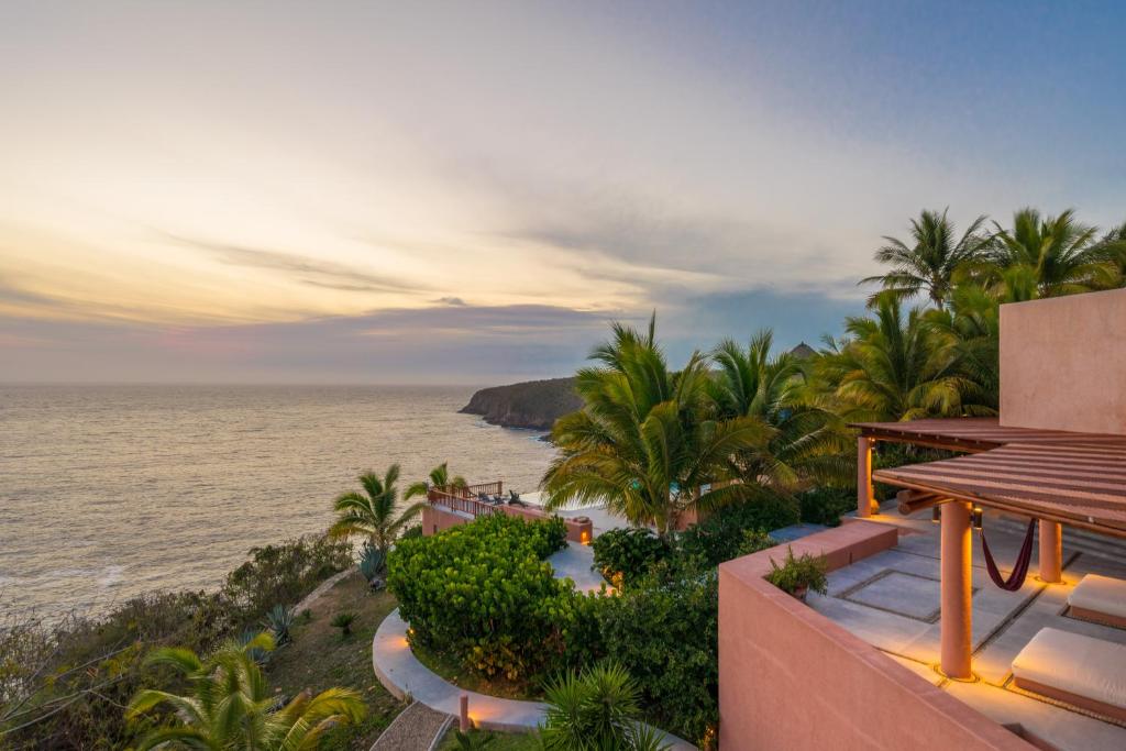 a view of the ocean from a house at Villa La Ceiba in La Huerta