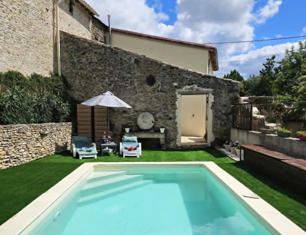a swimming pool in the yard of a house at Love Room "Les Secrets de Winna" in Augé