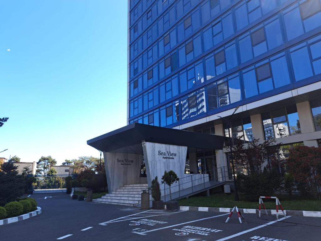 a large building with a sign in front of it at Olimp Sea View Studio in Olimp