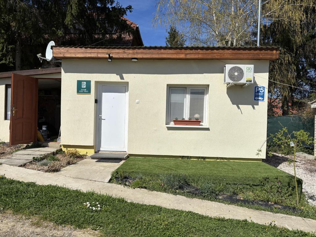 a small house with a white door and a window at Home for two in Igal