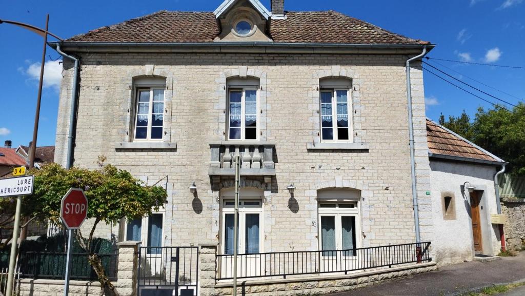 a brick house with a stop sign in front of it at Le Balcon de la Pierre Claire in Villersexel