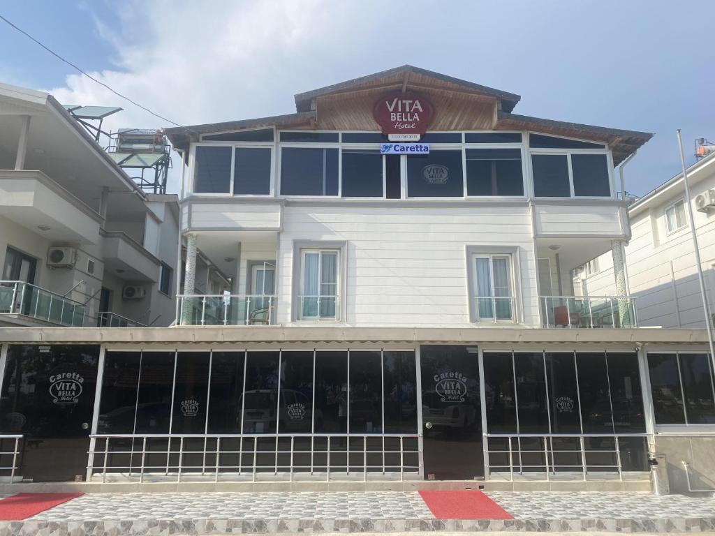 a white building with a sign on top of it at Caretta Vita Bella in Silifke