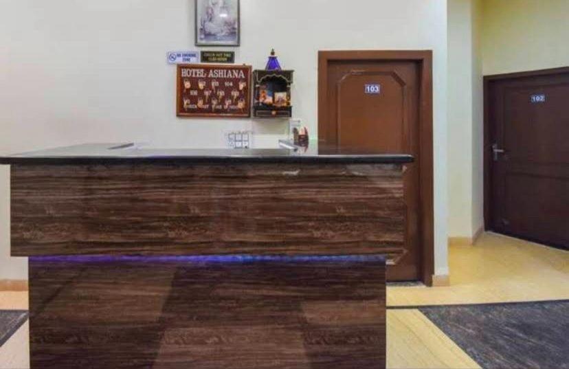 a large counter in a room with a door at Fab Krishna hotal in Panchkula
