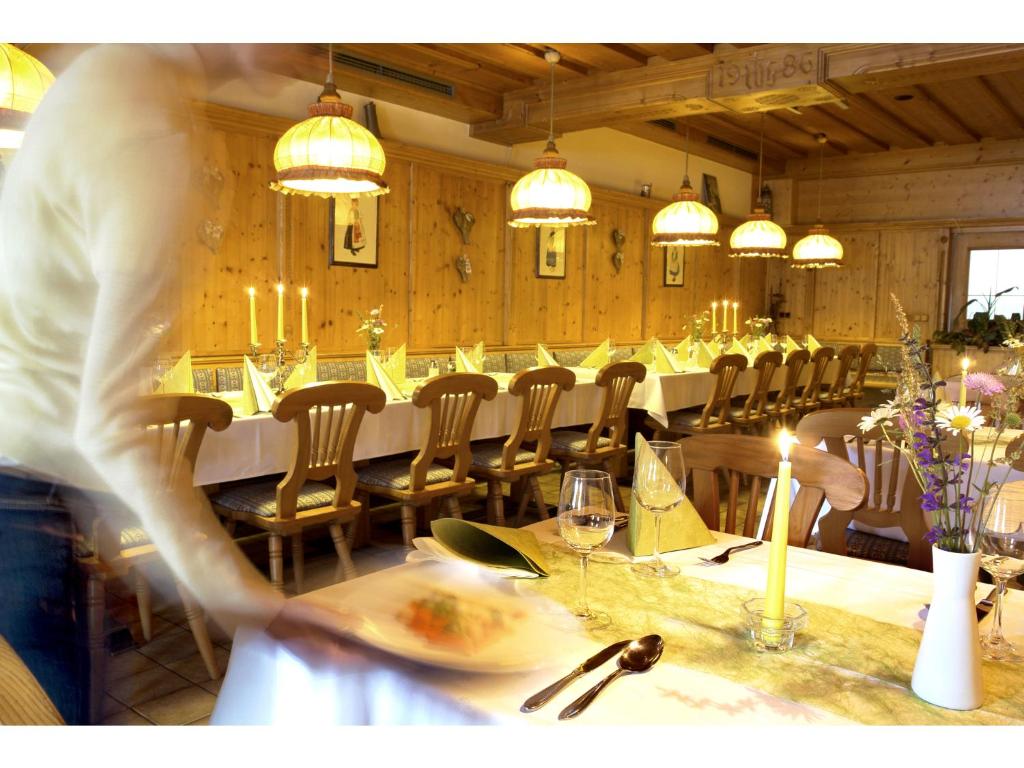 a person standing at a long table in a restaurant at Landgasthof Sengstbratl in Wallsee