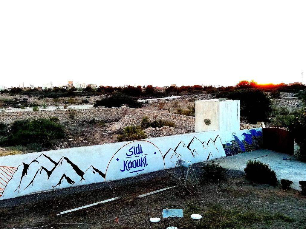 a wall with graffiti on the side of it at Villa Rabia in Sidi Kaouki