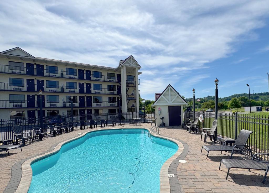 a swimming pool in front of a building at Landmark Inn On The River Sevierville in Sevierville