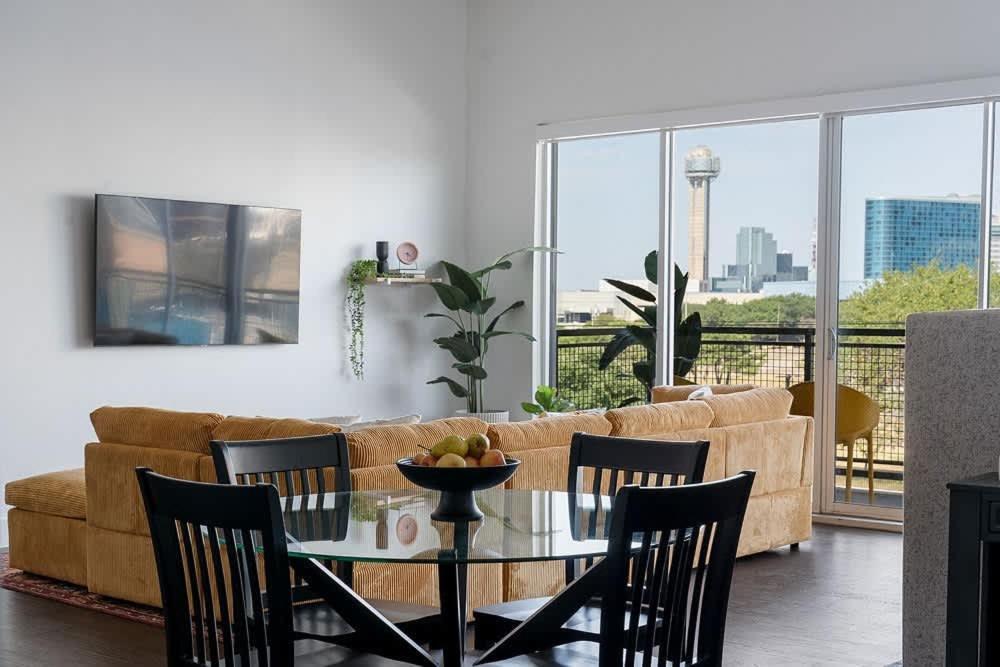 a living room with a couch and a table and chairs at Million Dollar Fireworks View no 412 in Dallas