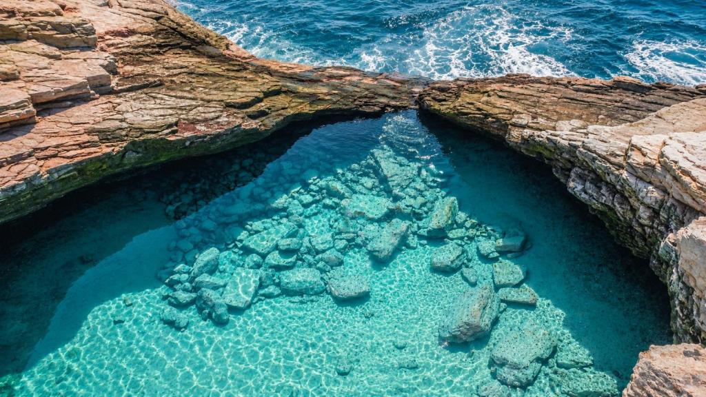 an aerial view of a rock bridge over the ocean at Euro Park Hotel in Astris
