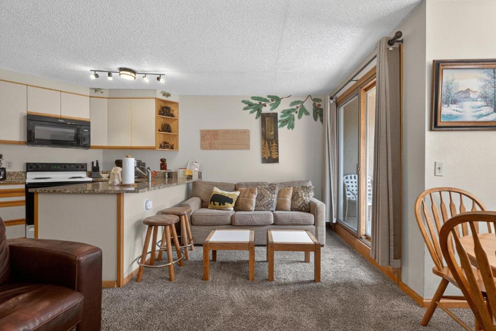 a living room with a couch and a kitchen at Iron Horse Building C Unit 1023 in Winter Park