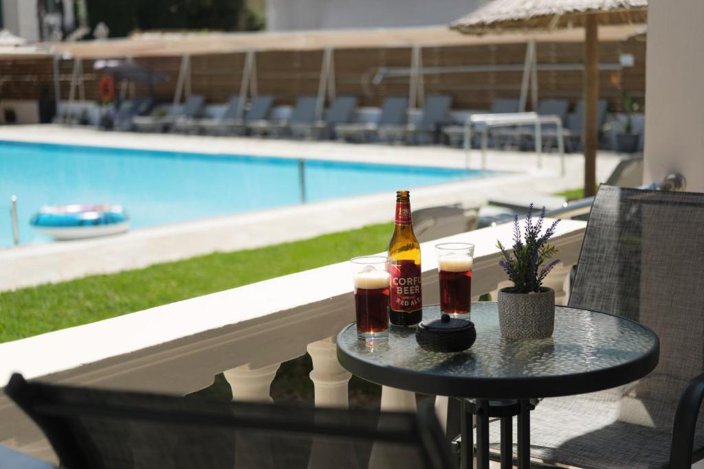 a table with two bottles of beer and two glasses at Katsaros Studios & Apartments in Sidari