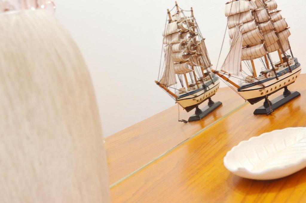 two model ships sitting on a wooden table at Cozy Central Nest Kotor in Kotor