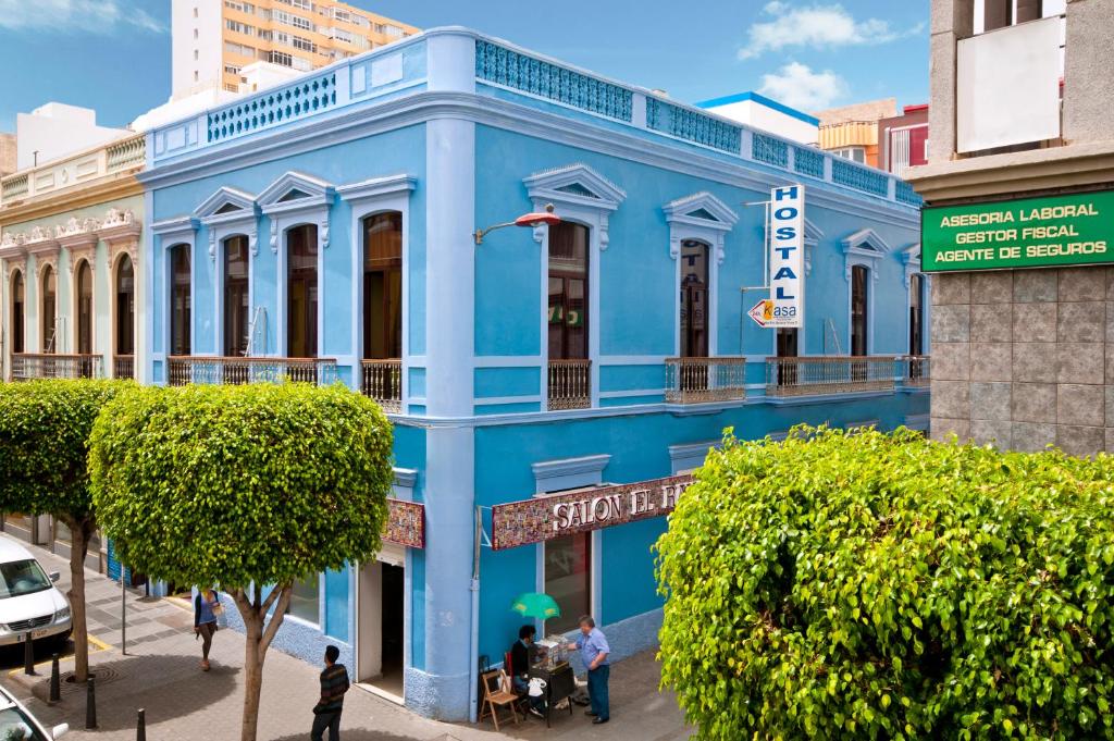 a blue building with a sign on the side of it at Hostal Kasa in Las Palmas de Gran Canaria