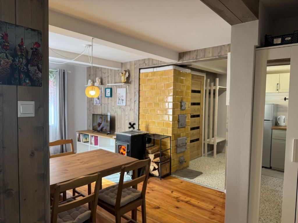 a kitchen and dining room with a table and chairs at Chatka w Narwi in Narew