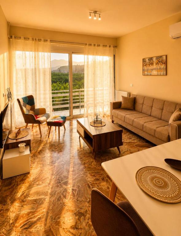 a living room with a couch and a table at MariosGuestHouse in Ancient Epidauros