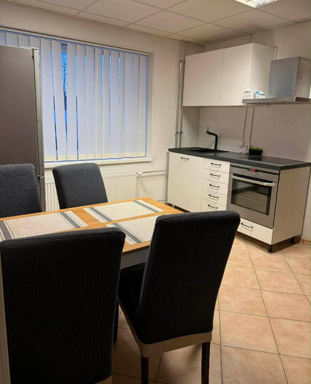 a kitchen with a table and chairs in a room at Paide Apartment in Paide