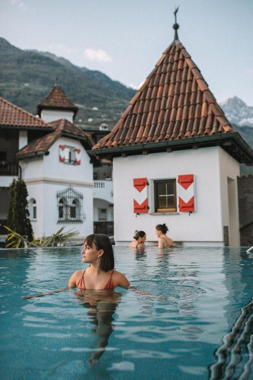 three women in the swimming pool at a resort at Vitalpina Hotel Schulerhof in Plaus