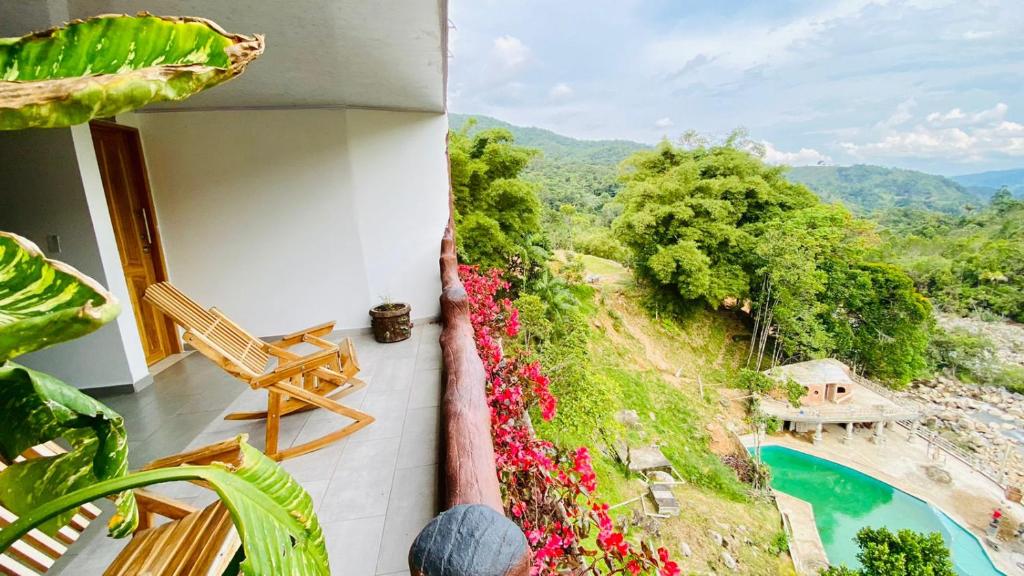 a balcony with a view of a pool and flowers at Eco hotel el molino in San Luis