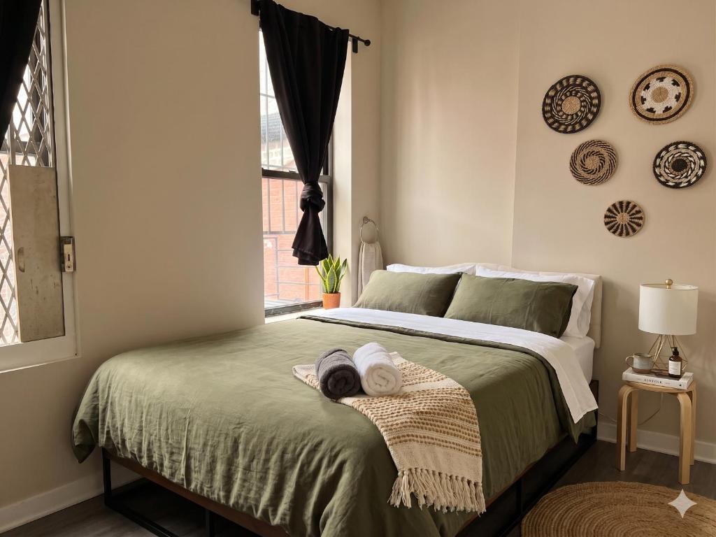 a bedroom with a bed with towels on it at The Ultimate NYC Base 1BR near Times Sq & Columbus Circle in New York