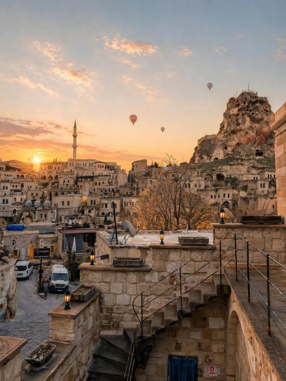 a view of a city with hot balloons in the sky at Masar Cave Konak in Ortahisar
