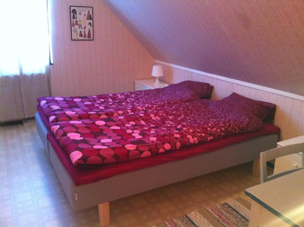 a bedroom with a bed covered in pink hearts at Barbro 9 in Borlänge