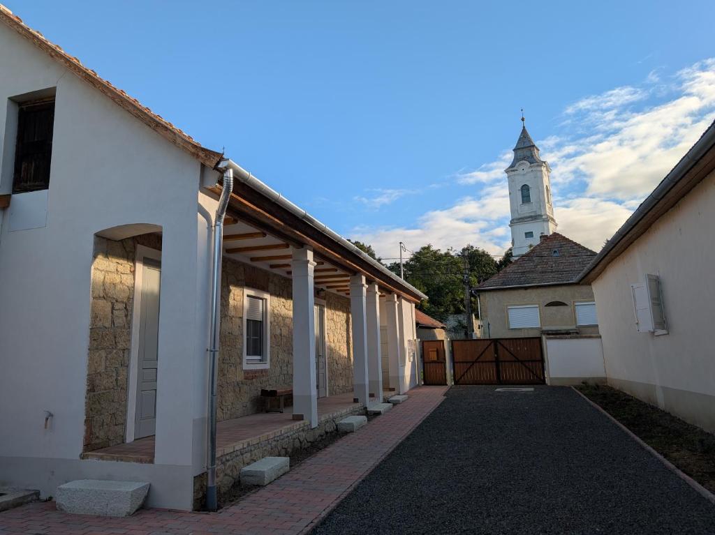 a building with a church with a clock tower at Maison Bátori Tarczal in Tarcal