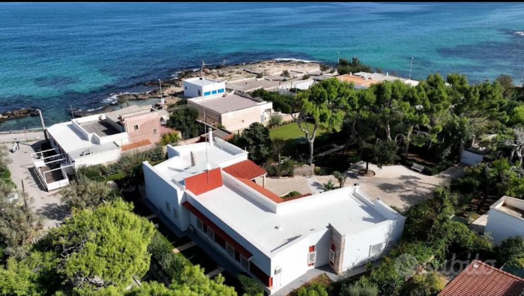 an aerial view of a building next to the ocean at Villa Paola by the sea in Cozze