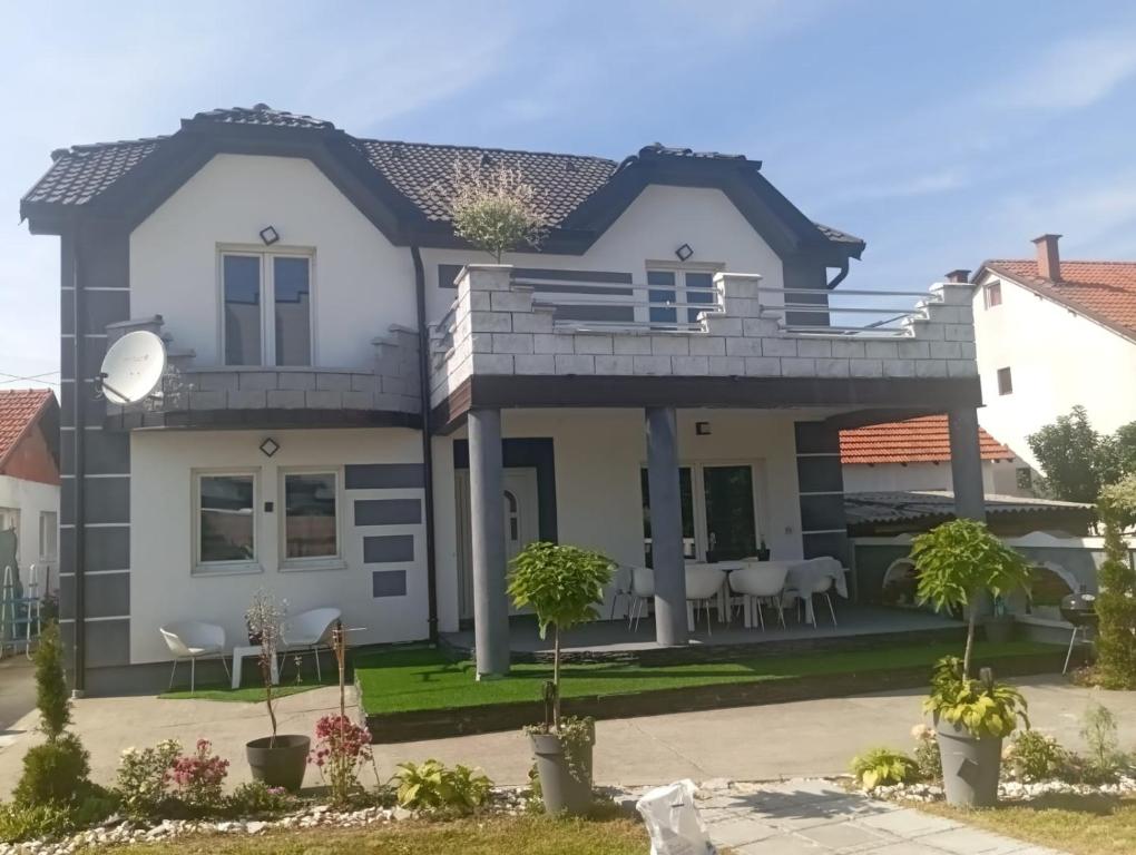 a house with a large deck and patio at Vila city in Bijeljina