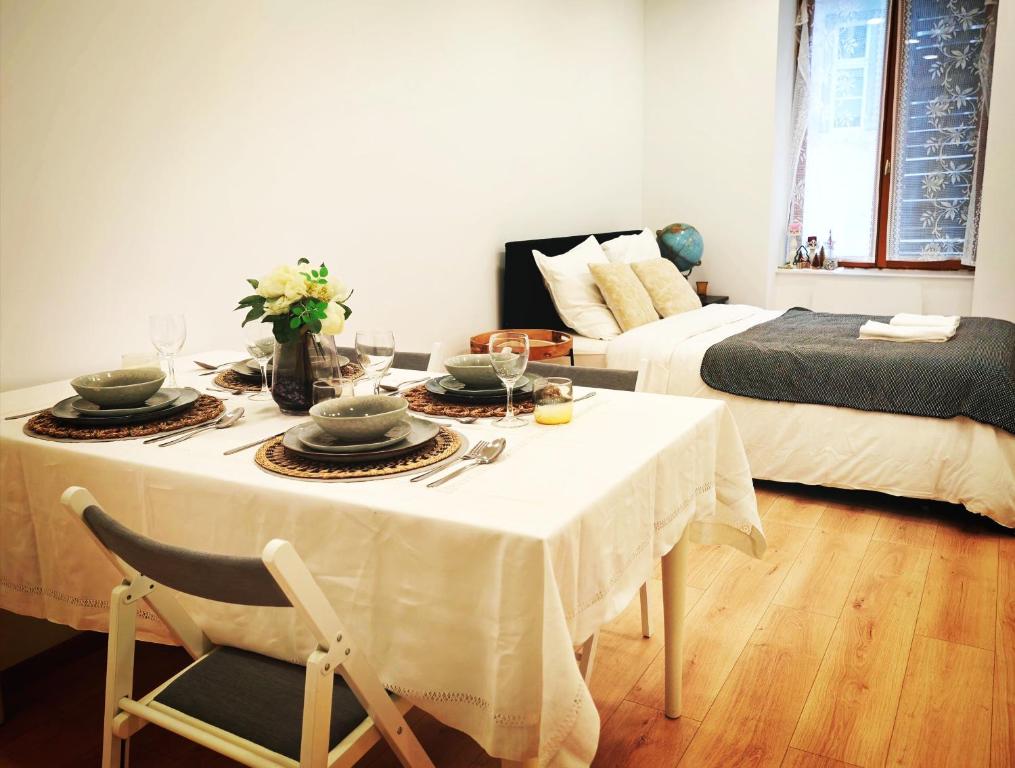 a living room with a table and a bed at Chez Alice 1 in Montbéliard