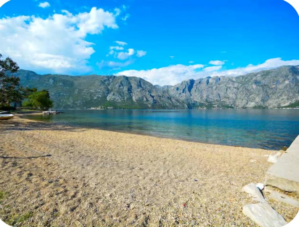a view of a lake with mountains in the background at Capri apartments in Kotor