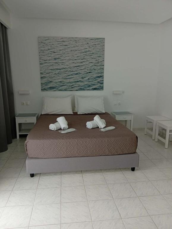 a bedroom with a bed with two pillows on it at Casa al'tati studio 27 in Ialysos