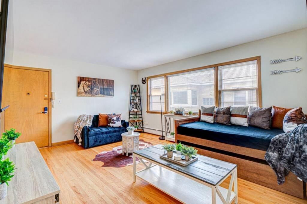 a living room with a couch and a table at King Bed • 2BR • Sleeps 13 • Historic Location in Elmwood Park