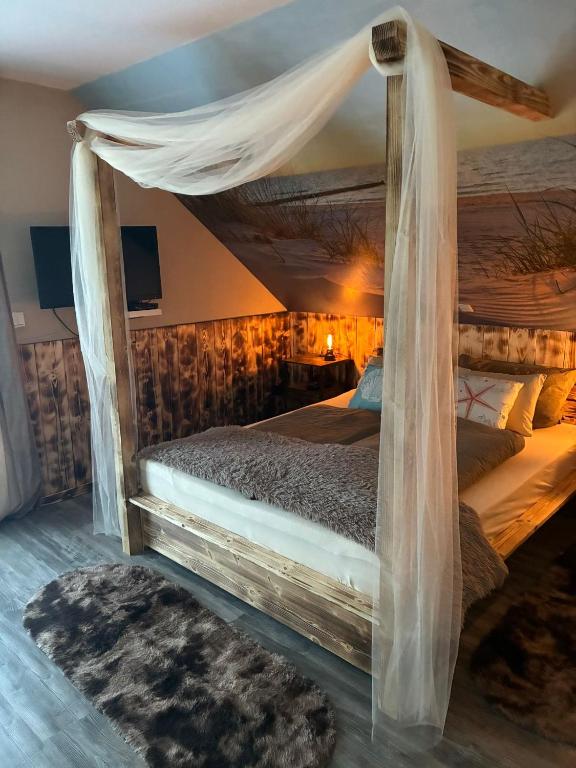 a bedroom with a bed with a canopy at Steintor Appartement in Kürten