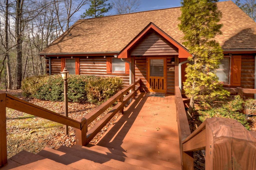 a cabin with a wooden ramp leading to a house at Honeys Haven in Morganton