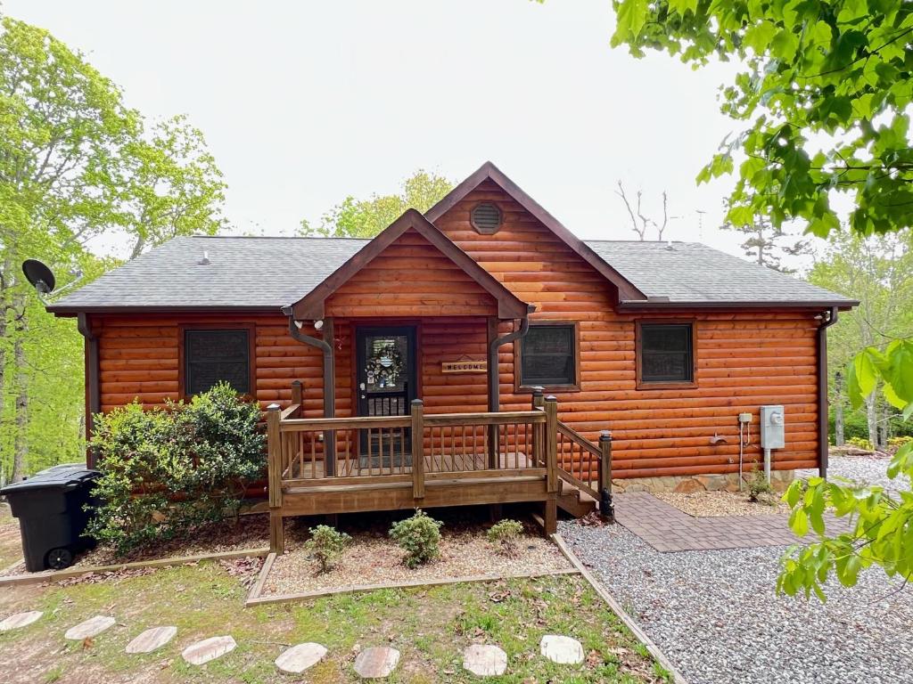 a log cabin with a porch and a deck at Lallybroch in Morganton
