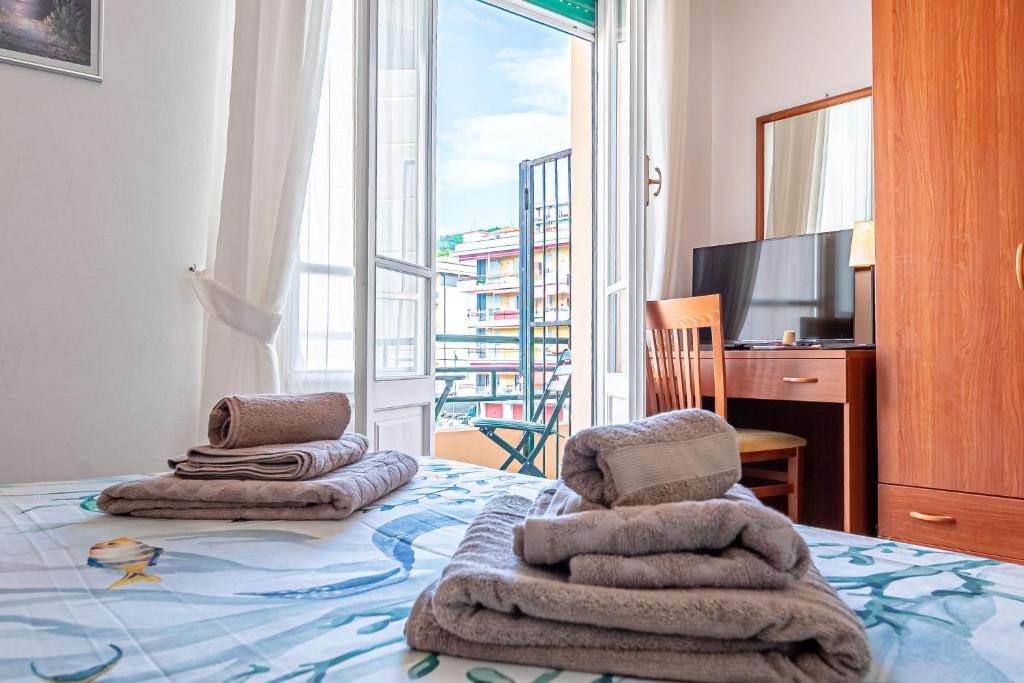 a bedroom with a bed with towels on it at Artemisia in Varazze