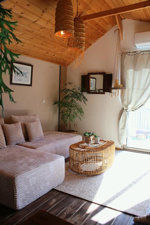 a living room with two beds and a table at Sunny's Suite in Safed