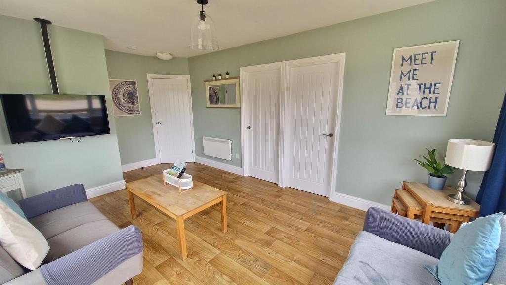 a living room with a couch and a table at 3 The Burrows in Braunton