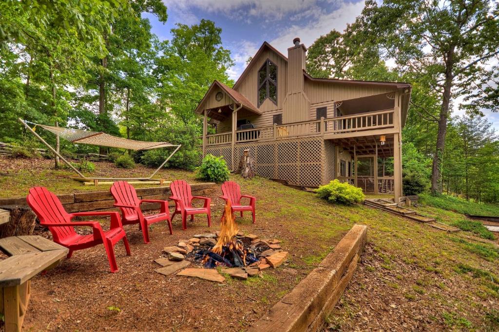 a backyard with chairs and a fire pit in front of a house at RendezView in Morganton