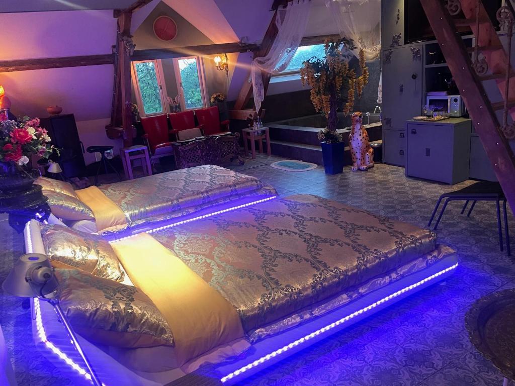 a bedroom with two beds in a room with purple lighting at CubaCasa in Den Bosch