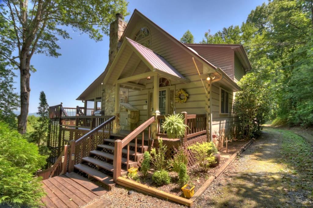 a small house with a porch and a deck at Storybook in Morganton