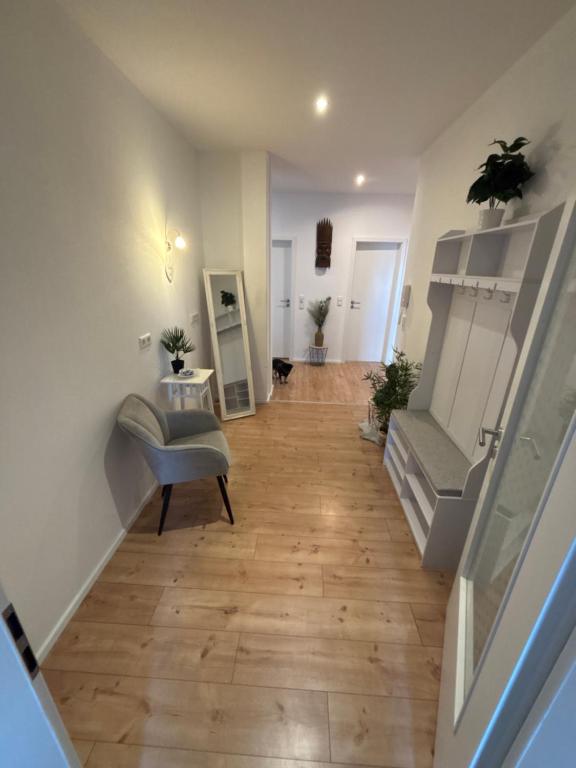 a hallway with a staircase with a couch and a chair at KC Appartments in Schwanau