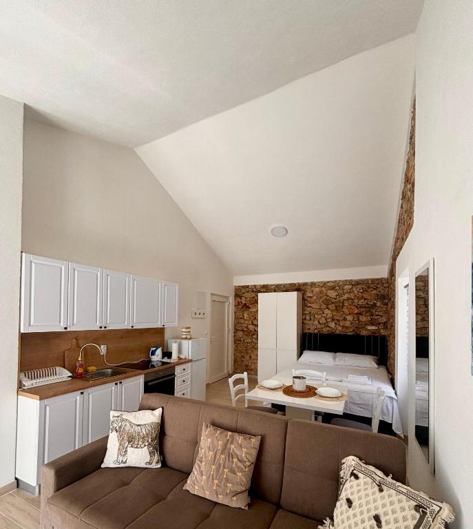 a living room with a couch and a bed at N E G R O Apartments - Novalja in Novalja