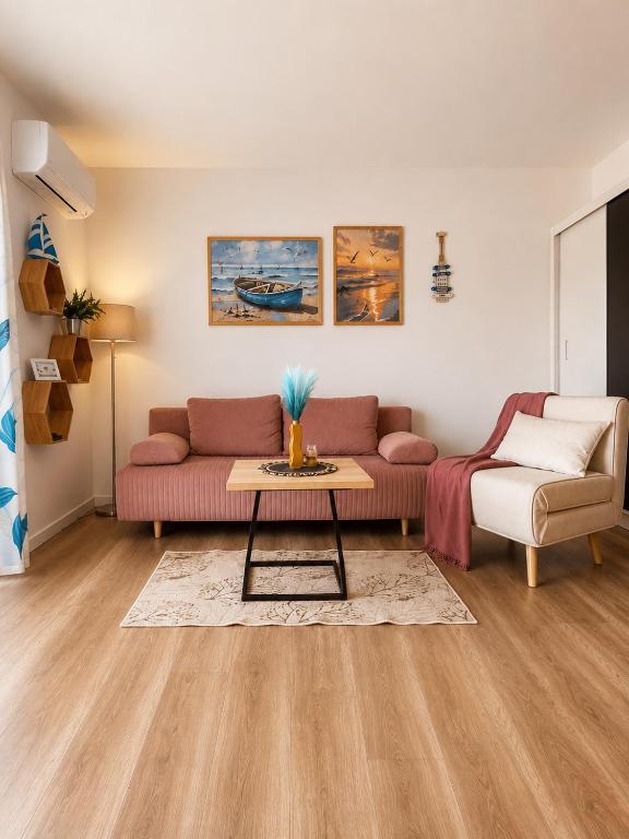 a living room with a couch and a table at Apartament SUNNY Rusinowo in Rusinowo