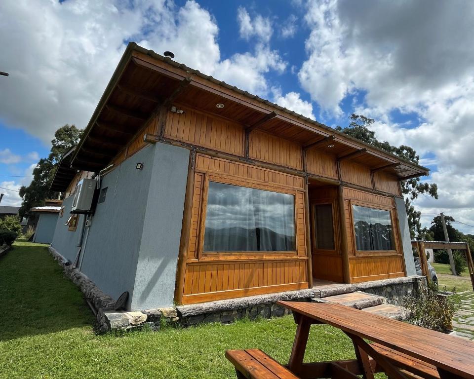 a small house with a picnic table in front of it at Sierras de Canela premium in Tandil